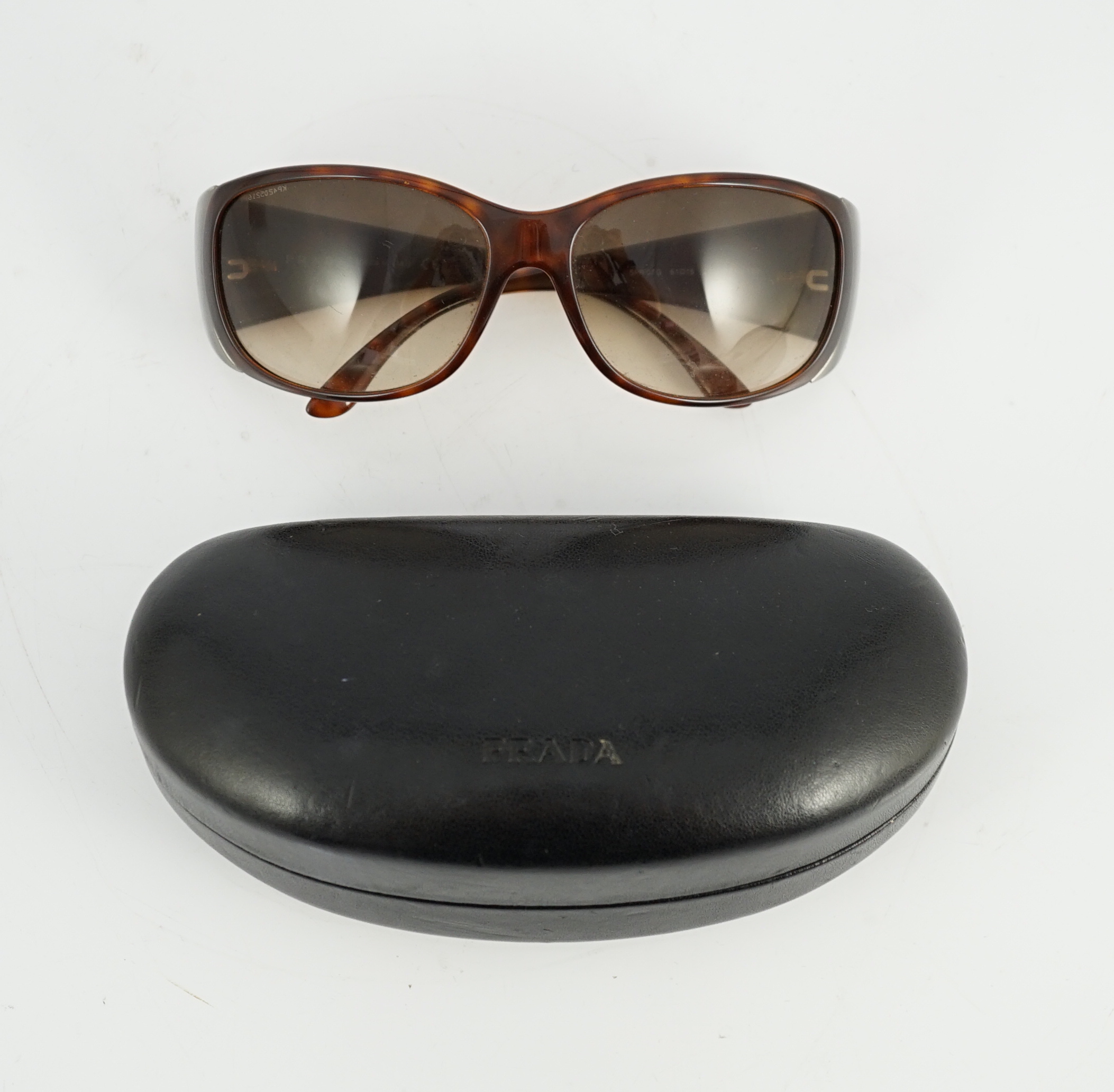 A pair of Prada tortoiseshell sunglasses